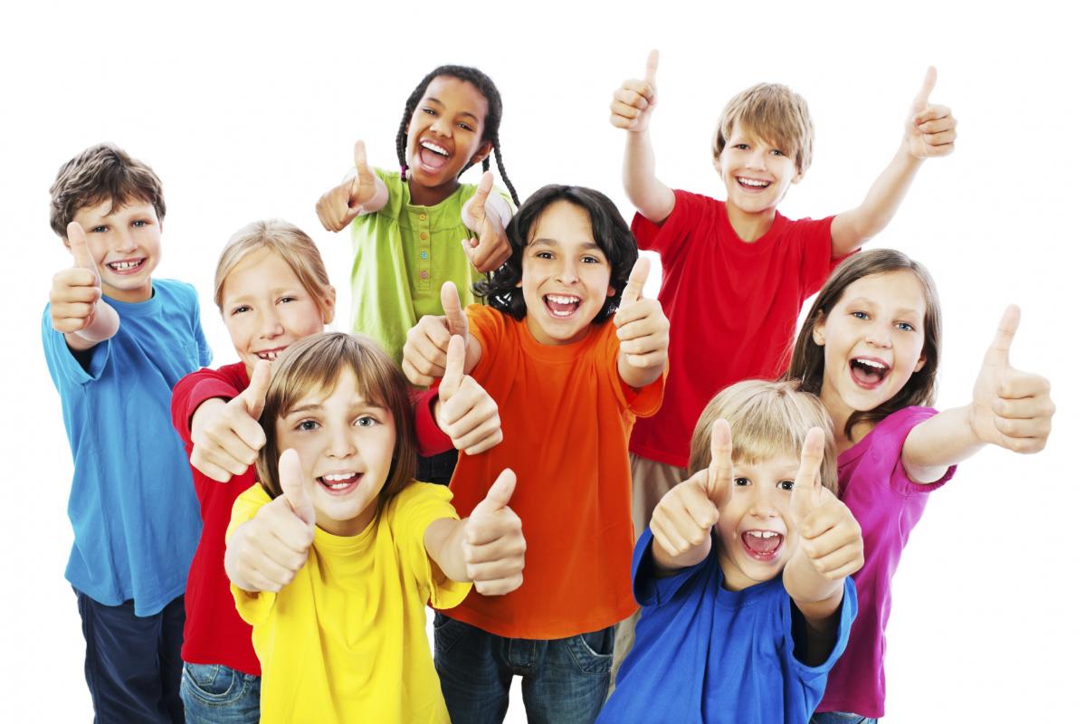 Eight children standing with their thumbs up in the air.